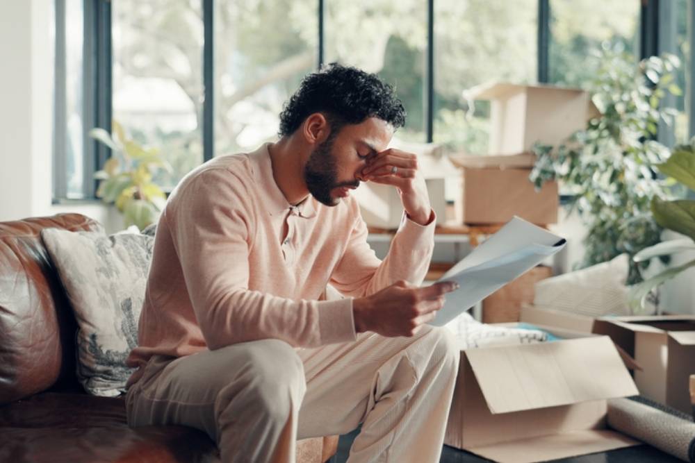 Moving in, man and stress with documents in new home for title deed error